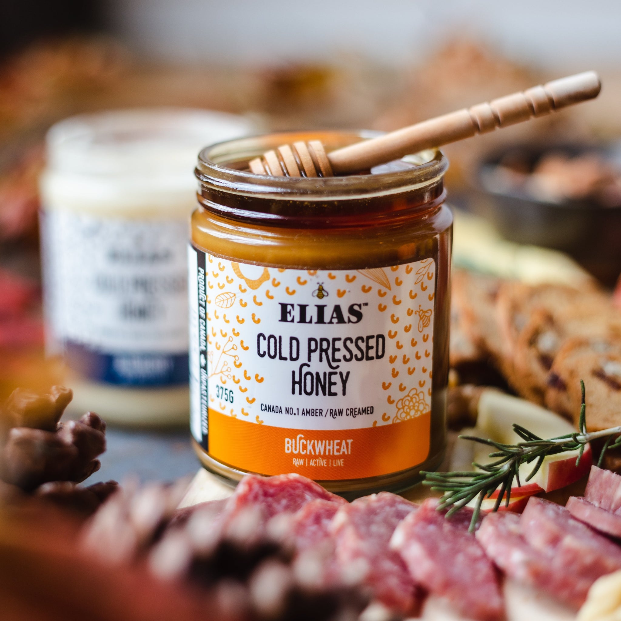Elias Cold Pressed Buckwheat Honey in a charcuterie board