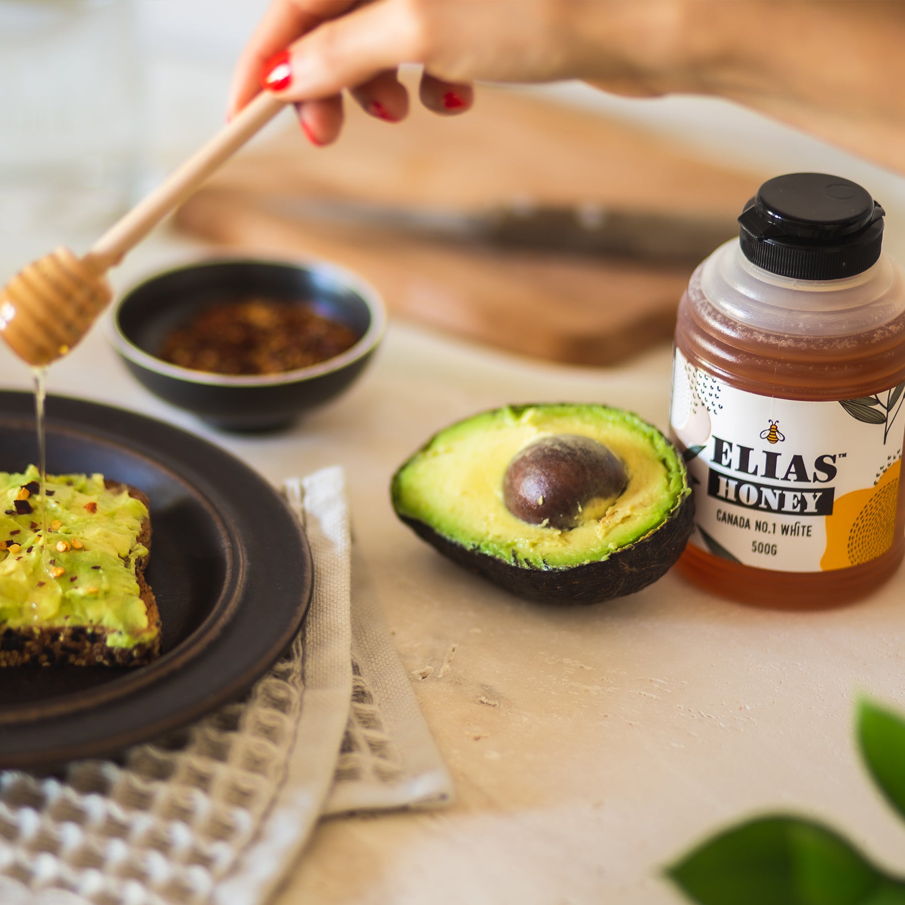 Image of Elias Canadian pure liquid honey being drizzled over avocado toast